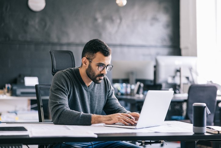 A man researches residential real estate investment options. 