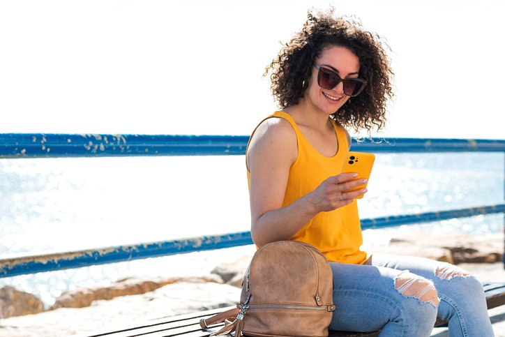 A woman looking up investments on her phone.