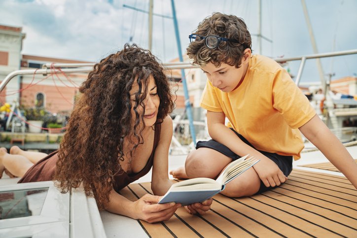 A mother enjoying a vacation with her son after earning returns from her investments.