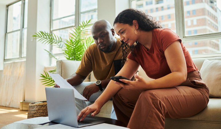 A couple reading the terms of a CD investment.