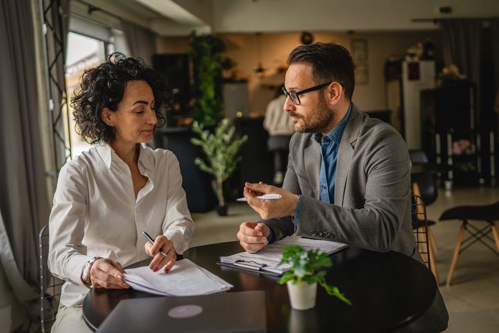 A financial advisor working with a client to select investments for growth and inflation management.