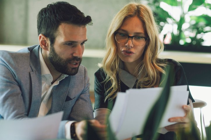 Financial advisors reviewing client portfolios. 